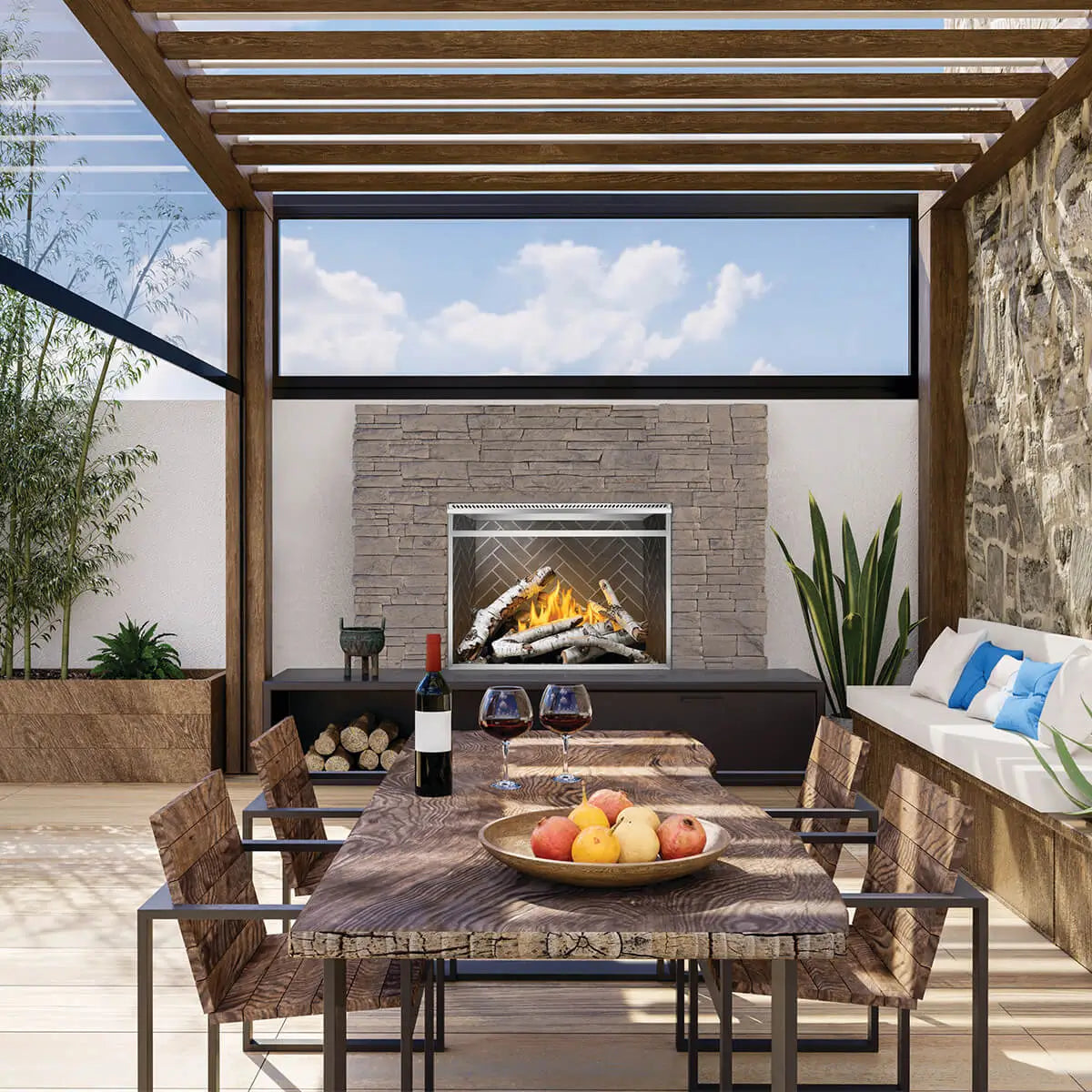 Stylish outdoor patio with a built-in gas fireplace insert, perfect for cozy gatherings with a beautiful stone wall backdrop.